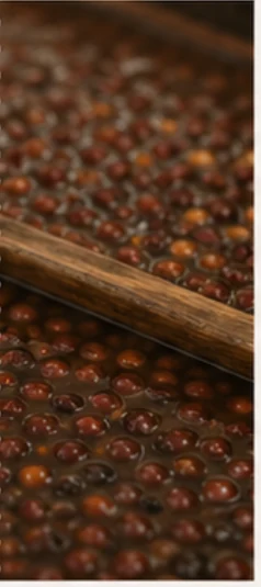 Coffee cherries fermenting in a wooden tray